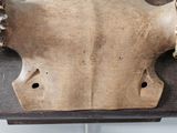 a cow ' s head on a wooden table with a chain around it