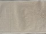 a white towel with a black border on a table