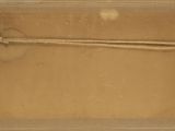 a box with a rope in it on a white surface