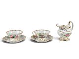 three pieces of porcelain tea set with saucers and cups