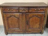 a wooden cabinet with two drawers and a door