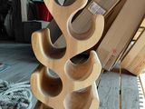 a wooden wine rack that is on a wooden table