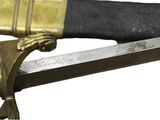 a close up of a sword with a gold handle