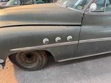 an old car that is parked on the side of the street