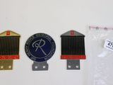 deux radiateurs et un insigne sur une surface blanche