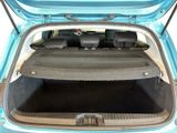 a trunk of a small blue car with its doors open
