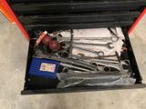 many tools in a tool box on the floor