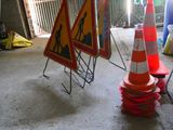 two traffic cones sitting on the ground next to each other
