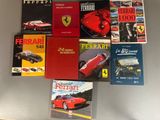 Plusieurs livres sur Ferrari sont empilés les uns sur les autres sur une table