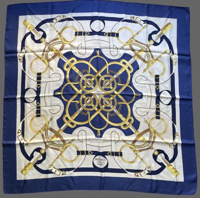 a blue and white scarf with a gold design on it