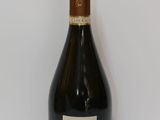 an old bottle of champagne sitting on a white surface