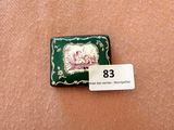 a small green box with a picture on it