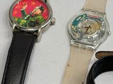 three watches sitting on a table next to each other
