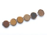 an image of a close up of a bracelet with a clock on it