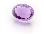 a purple amethorate gems on a white surface