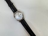an image of a watch on a white surface with a black strap