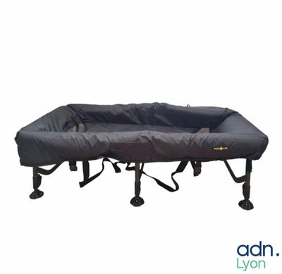 a close up of a bed with a black cover on it