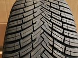 a close up of a tire on a wooden surface with boxes in the background