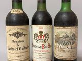 trois bouteilles de vin sont alignées sur une surface blanche