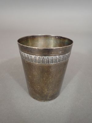 a silver cup that is sitting on a table