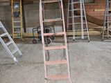a ladder that is standing in the middle of a room