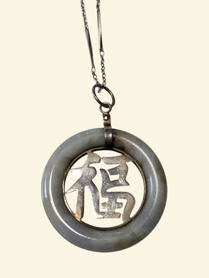 a picture of a necklace with a picture of a man on it
