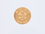 a gold coin on a white surface with a white background