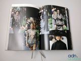 an open book with a picture of a woman in a dress and a man in a top hat