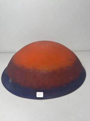 an orange and blue bowl sitting on a white surface