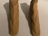 pair of tan boots with zippers on the side of them