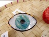 a glass eye that is sitting on top of a table