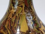 a vase that is sitting on a table with a white background