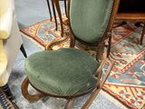a green chair that is sitting on a rug in a room