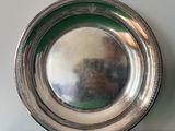a silver plate on a green counter top