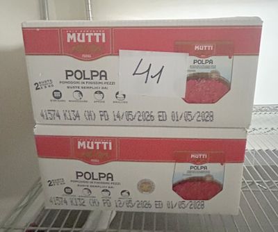 two boxes of food sitting on a shelf in a refrigerator