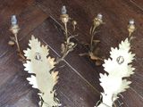 two candles that are sitting on a wooden floor