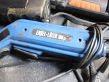 a blue electric tool sitting on top of a black table