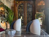two vases sitting on top of a clear table
