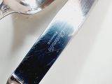 a silver spoon and a silver spoon on a white table