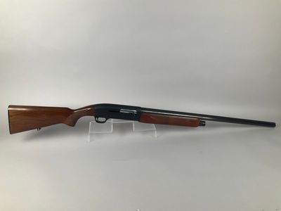 a shotgun with a wooden barrel and a black handle