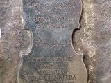 an antique silver plate with a plaque of a woman ' s head