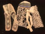 three pieces of lace are displayed on a black surface