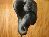a sculpture of a dog ' s head on top of a wooden stand