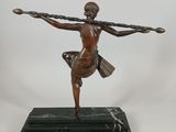 bronze statue of a woman holding a spear on a black marble base