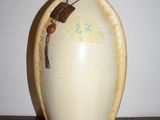 a vase with a bug on it sitting on a table