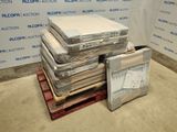 a pile of mattresses sitting on a pallet in a room
