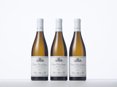 three bottles of wine sitting on top of a white table