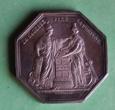 a close up of a coin with a man and a woman on it