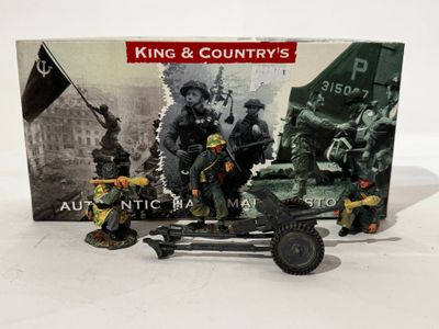 figurines of a toy army vehicle with soldiers and a flag
