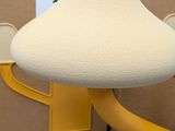 a mushroom shaped light that is attached to a wall